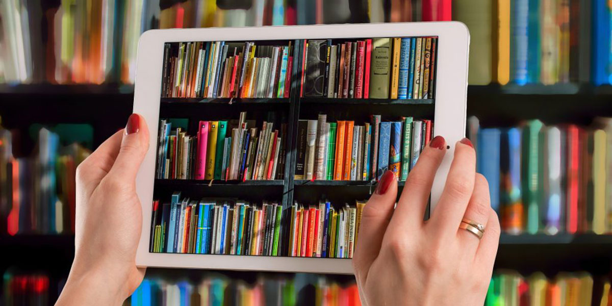 A person using a tablet to take a photo of books.